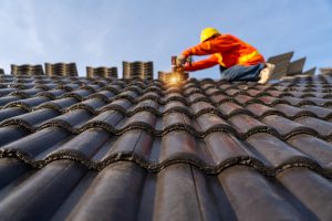 A Construction Worker Install New Tile Roofing